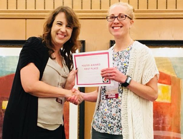 Receiving the Early Career Psychologists Poster Award from Dr. Stein at the Society for the Teaching of Psychology Annual Conference on Teaching